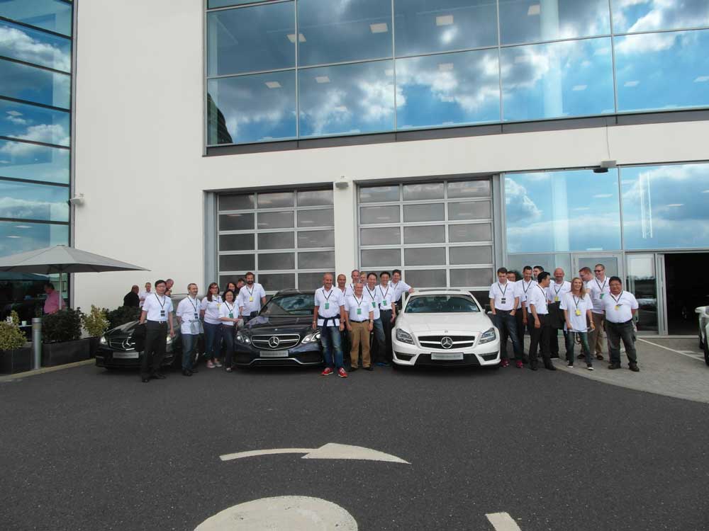 Professional event management team outside corporate office with luxury Mercedes cars, team building, conference planning, and corporate event services.