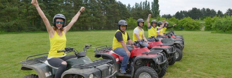 Corporate away day: People on quad bikes. Team building outdoor activity.